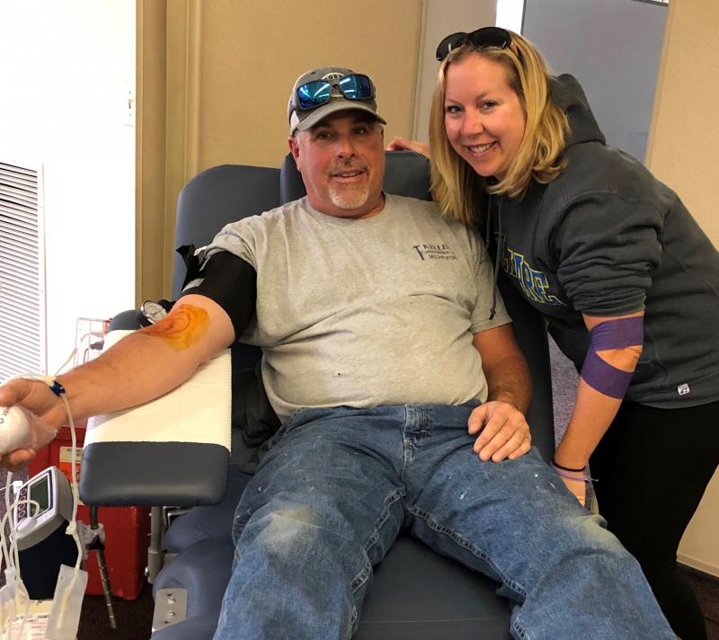 Scott Keller, left, and Amy Popovich donate blood to support their community. SUBMITTED PHOTO
